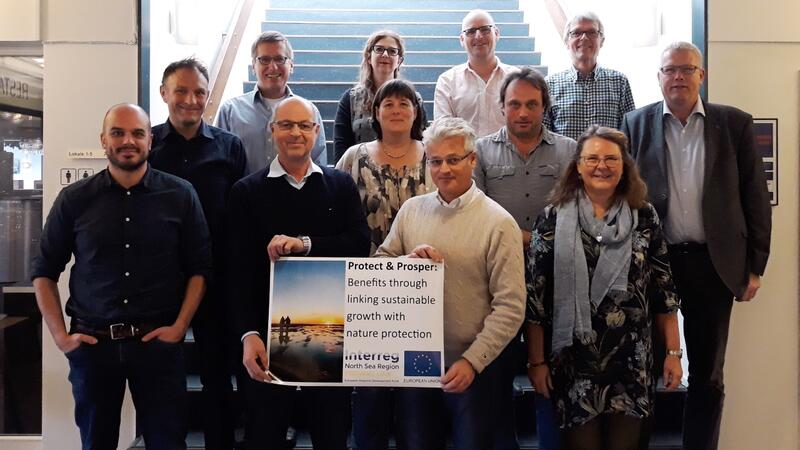 Participants of the Esbjerg meeting standing in front of stairs. © Nationalpark Vadehavet. Participants of the Esbjerg meeting standing in front of stairs. © Nationalpark Vadehavet.