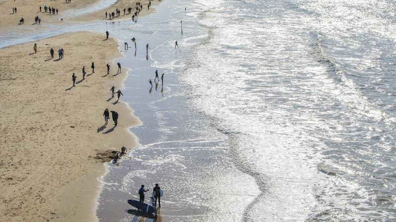 Aerial photo of beach shore with people. © unsplash.com. Aerial photo of beach shore with people. © unsplash.com.