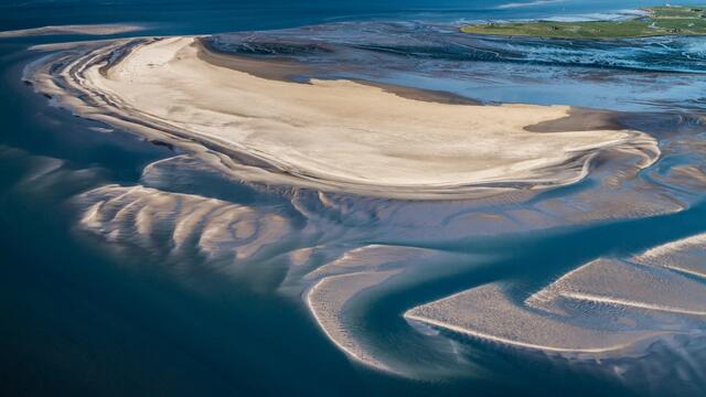 Aerial photo of a sandbank enclosed by waters. © Stock/LKN.SH.